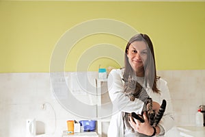 Veterinary clinic. Female doctor portrait at the animal hospital holding cute sick cat