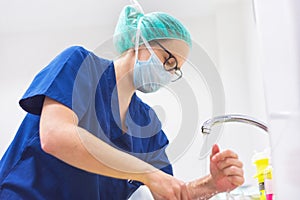 Veterinary surgeon washing hands before operating