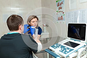 Vets do an ultrasound scan of the dog`s injured eye in a veterinary. Animal health care concept