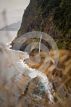 Veu da Noiva Viewpoint of Waterfall falling into the Ocean, Madeira, Portugal photo