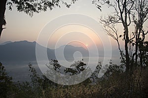 Vew of phu tok mountain with mist and sun at viewpoint in morning