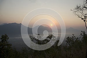 Vew of phu tok mountain with mist and sun at viewpoint in morning