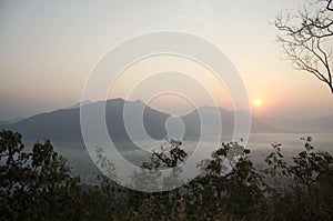 Vew of phu tok mountain with mist and sun at viewpoint in morning