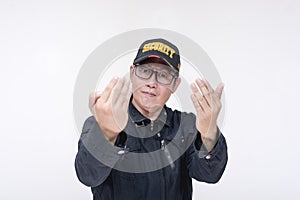 A vexed male security guard challenges someone to come closer. Commanding gesture with palm. Isolated on a white background
