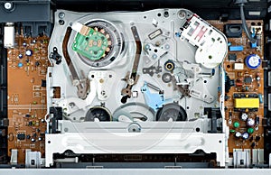 VHS video recorder inside without video cassette, view of the tape mechanism. Top view