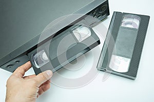 VHS videocassette is put into the video recorder to watch the video, another video cassette