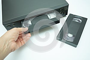 VHS videocassette is put into the video recorder to watch the video, another video cassette