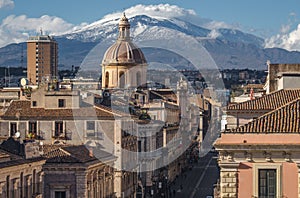 Via Etnea in Catania. Dome of Catania and the main street with the background of volcano Etna