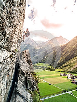 Via ferrata climber climbs vertical rock, Reinhard Schiestl Klettersteig, Austria photo