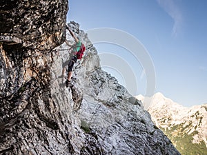 Via ferrata climber high on the rock