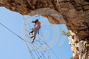 Via Ferrata - Girl Hanging on the Metal Net