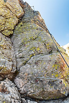 Via ferrata with stemples and steel cable leads to Priecne sedlo in Vysoke Tatry mountains in Slovakia