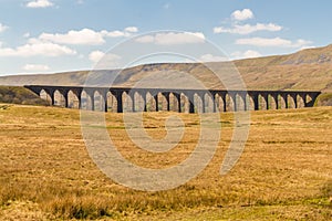 Viaduct with many arches in a beautiful countryside landscape.