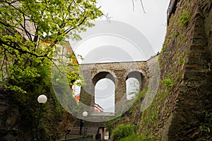 Viaduct and view from below on the stone structure of the bridge of Cesky Krumlov with famous Cesky Krumlov Castle, Church city on