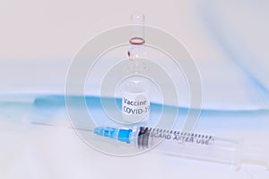 A vial ampoule of coronavirus vaccine along with injection syringe