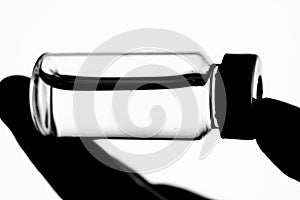 Vial filled with liquid on white background