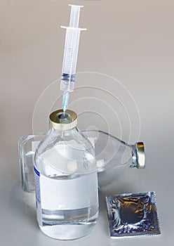 A vial of medicine with a syringe