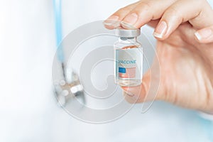 Vial with new usa, american vaccine for covid-19 coronavirus, flu, infectious diseases. Hand of doctor, nurse. Injection after