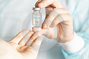 Vial with new usa, american vaccine for covid-19 coronavirus, flu, infectious diseases. Hand reaches to doctor. Injection after