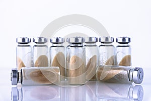 Vials, ampoules with dry probiotic, bifidobacteria, with probiotic powder inside on a white background. Copy space