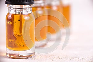 Vials of CBD oil, cannabis live resin extraction on whi