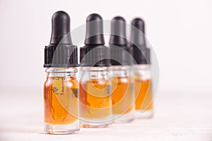 Vials of CBD oil, cannabis live resin extraction on whi