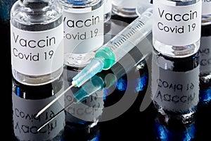 Vials of Covid-19 vaccine and syringe.