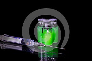 Vials with green toxic steroids and syringe photo