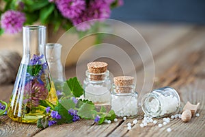 Vials of tincture of healthy herbs and bottles of homeopathy globules. photo