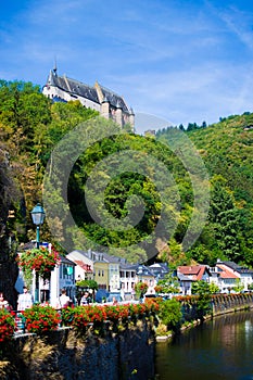 Vianden Castle on a hill with houses and Our river in Vianden, Luxembourg