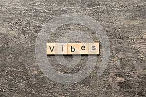 vibes word written on wood block. vibes text on table, concept