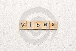 vibes word written on wood block. vibes text on table, concept