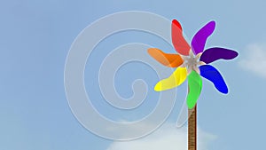 VIBGYOR Coloured Spinning Pin wheel against cloudy Sky animated video footage