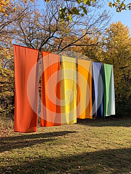 Vibrant Autumn Papers Outdoors Colorful fabrics hang outdoors in an autumnal setting symbolizing joy nature creativity photo