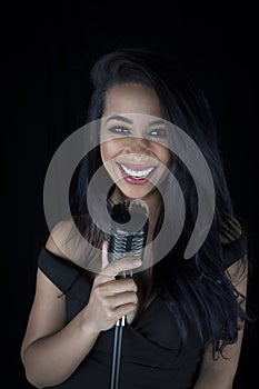 Vibrant black singer with a captivating smile, holding a classic mic