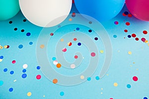 Vibrant blue background with glittering confetti and air balloons, card for celebration art with copy space