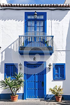 Vibrant Blue Balcony and Doors in White Building