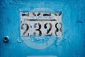 Vibrant blue house post Numbers adorn this eye-catching house post, creating an intriguing focal point against the vivid blue