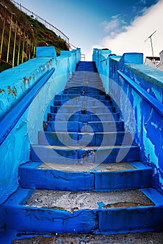 Vibrant blue staircase against a clear sky