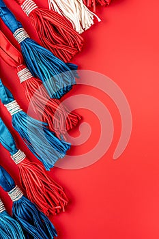 Vibrant Blue and White Tassels Border Arrangement on Vivid Red Background for Creative Projects