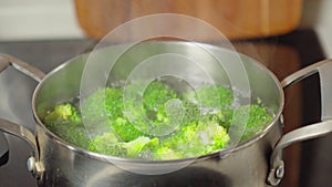 Vibrant Broccoli Florets Simmering in Steamy Pot. Selective focus