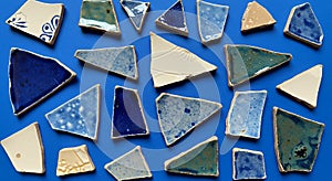 Vibrant Broken Ceramic Shards on Blue Background