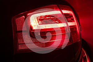 Vibrant and captivating sight of a vehicle's rear lights glowing red in the dark