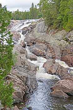 Vibrant Cascade Cutting Through a Rocky Channel