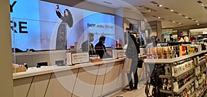 Vibrant cash counter at Marks and Spencer with backlit photo