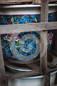 Vibrant ceramic bowl is presented on a wodoen rack