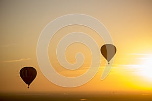 Vibrant, colorful, hot air balloons during sunrise