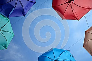 Vibrant colorful opened umbrellas in the sky background
