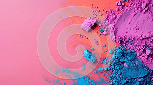 Vibrant colorful piles of purple and blue pigment powders on pink background at the right side of image. Suitable for Holi