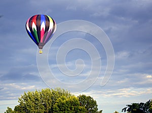 Vibrant Colorful Piloted Helium Hot-Air Balloon in Flight